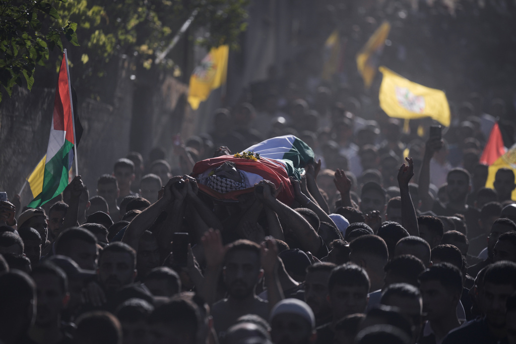 Mourners carry the body of Palestinian Imad Haroun Ishtayeh, 26, who was shot and killed by Israeli forces on Sunday at a concrete barrier separating the occupied West Bank from Jerusalem, during his funeral in the village of Salem, east of Nablus, Sunday, May 31, 2026. (AP Photo/Majdi Mohammed)