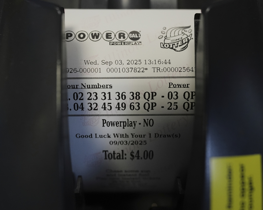 A Powerball lottery ticket is printed out of a lottery machine at a convenience store in Northbrook, Ill., Wednesday, Sept. 3, 2025. (AP Photo/Nam Y. Huh)