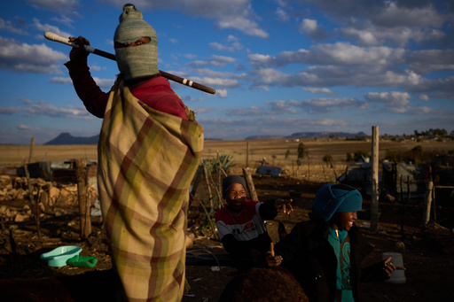 Boys stand outside their homes after a day of work in Mafeteng, Lesotho, July 12, 2025. (AP Photo/Bram Janssen) Boys stand outside their homes after a day of work in Mafeteng, Lesotho, July 12, 2025. (AP Photo/Bram Janssen)