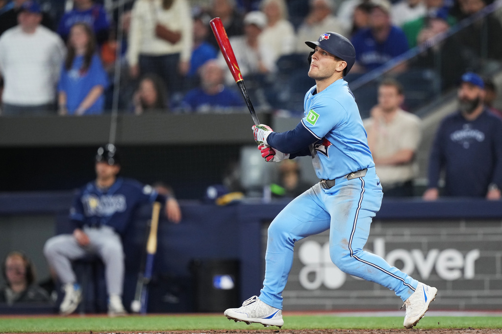 Toronto Blue Jays' Daulton Varsho (5) hits a walk-off grand slam against the Tampa Bay Rays during 10th inning MLB baseball action in Toronto on Wednesday, May 13, 2026. (Nathan Denette/The Canadian Press via AP)