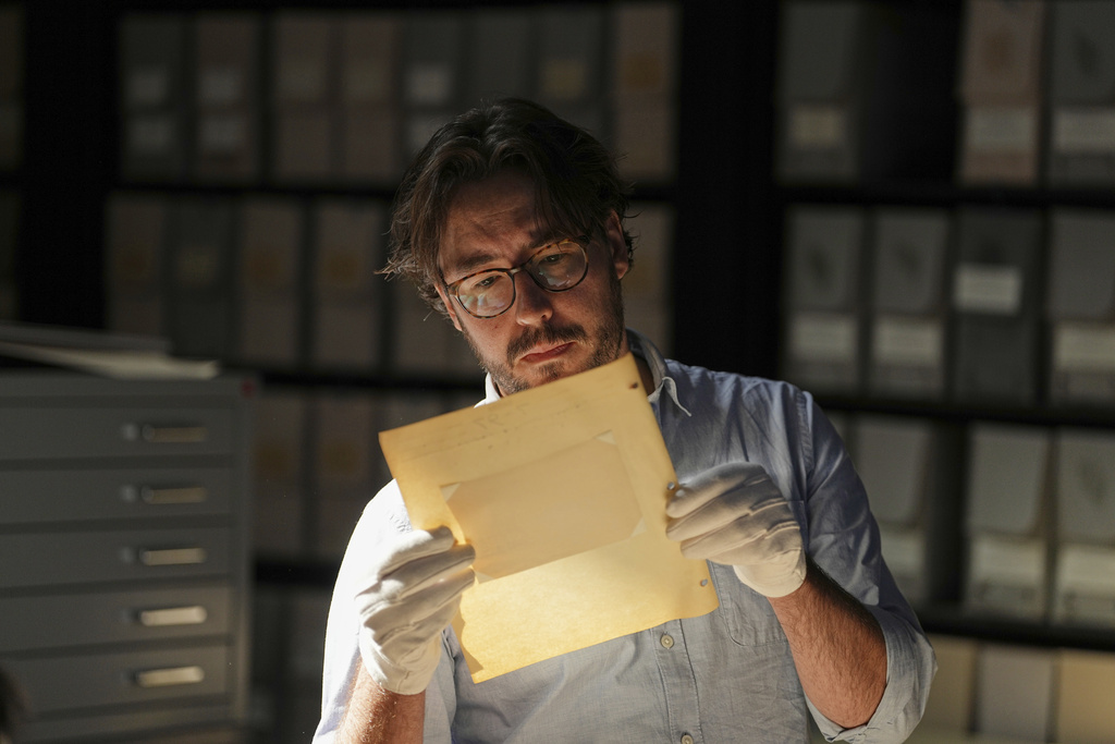 University of Victoria postdoctoral fellow Nathaniel Brunt views an image from a collection of photos of the Yazidi people in their northern Iraq homeland in the 1930s, during an interview at the Penn Museum Archives in Philadelphia, Aug. 27, 2025. (AP Photo/Matt Rourke)
