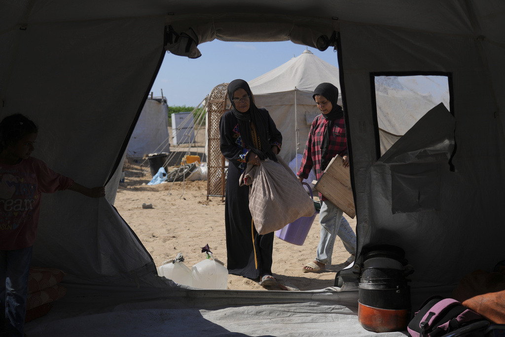 The Abu Jarad family moves their belongings into a newly built tent in Khan Younis, Gaza Strip, after being displaced from Gaza City, Sept. 11, 2025. (AP Photo/Abdel Kareem Hana)