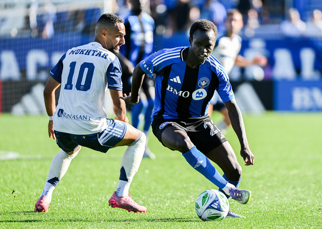 CF Montreal's Victor Loturi, right, gets by Nashville SC's Hany Mukhtar (10) during the second half of an MLS soccer game in Montreal, Saturday, Oct. 4, 2025. (Graham Hughes/The Canadian Press via AP)
