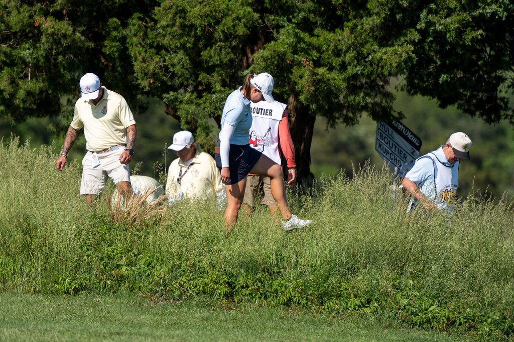 Jennifer Kupcho, center, gets help after she lost her ball on the fifth hole during the first round of the ShopRite LPGA Classic golf tournament, Friday, May 29, 2026, in Galloway, N.J. (AP Photo/Chris Szagola)