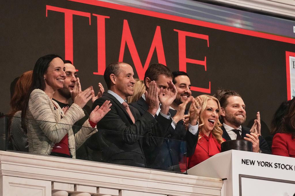 TIME CEO Jessica Sibley, second from right, joined by OpenAI Chief Global Affairs Officer Chris Lehane, second left, rings the New York Stock Exchange opening bell for TIME's "Person of the Year," Thursday, Dec. 11, 2025. (AP Photo/Richard Drew)
