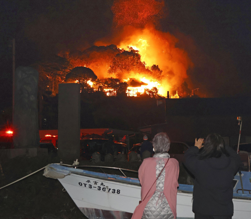 Smoke rises over buildings after a fire in Oita, southern Japan, Wednesday, Nov. 19, 2025. (Kyodo News via AP)