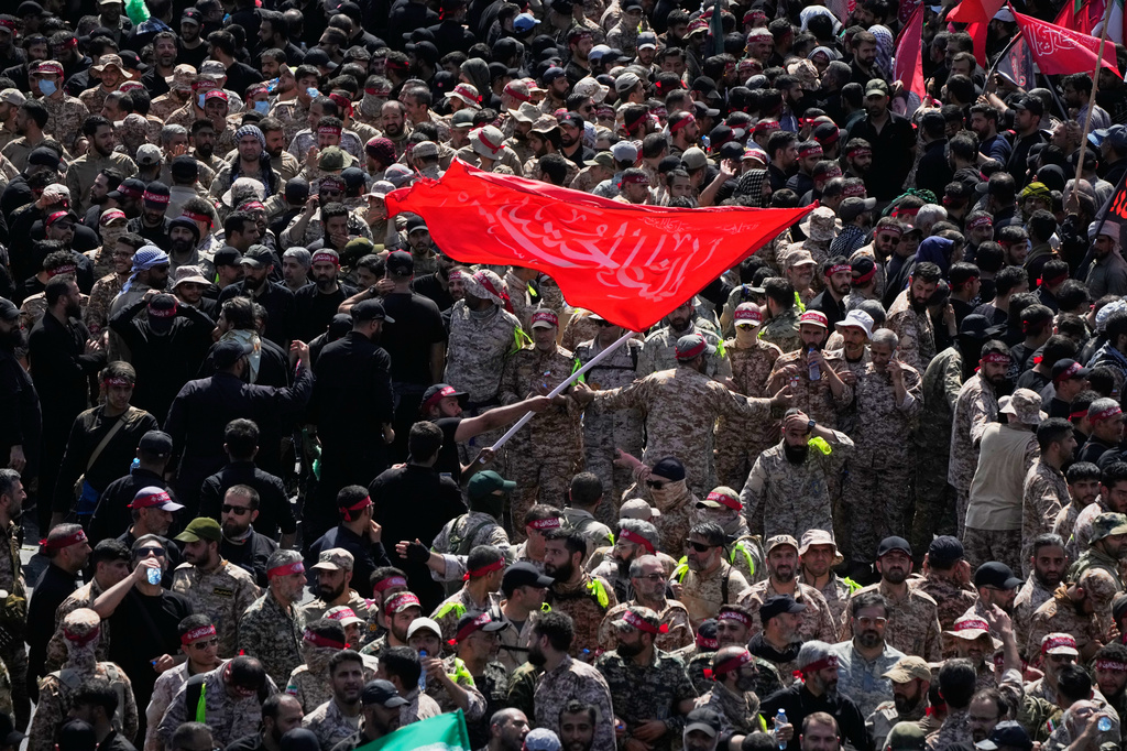 Uniformed members of the Islamic Revolutionary Guard Corps wave a Shiite religious flag during the funeral procession of the slain Iranian Supreme Leader Ayatollah Ali Khamenei and members of his family in Tehran, Iran, Monday, July 6, 2026. (AP Photo/Vahid Salemi)