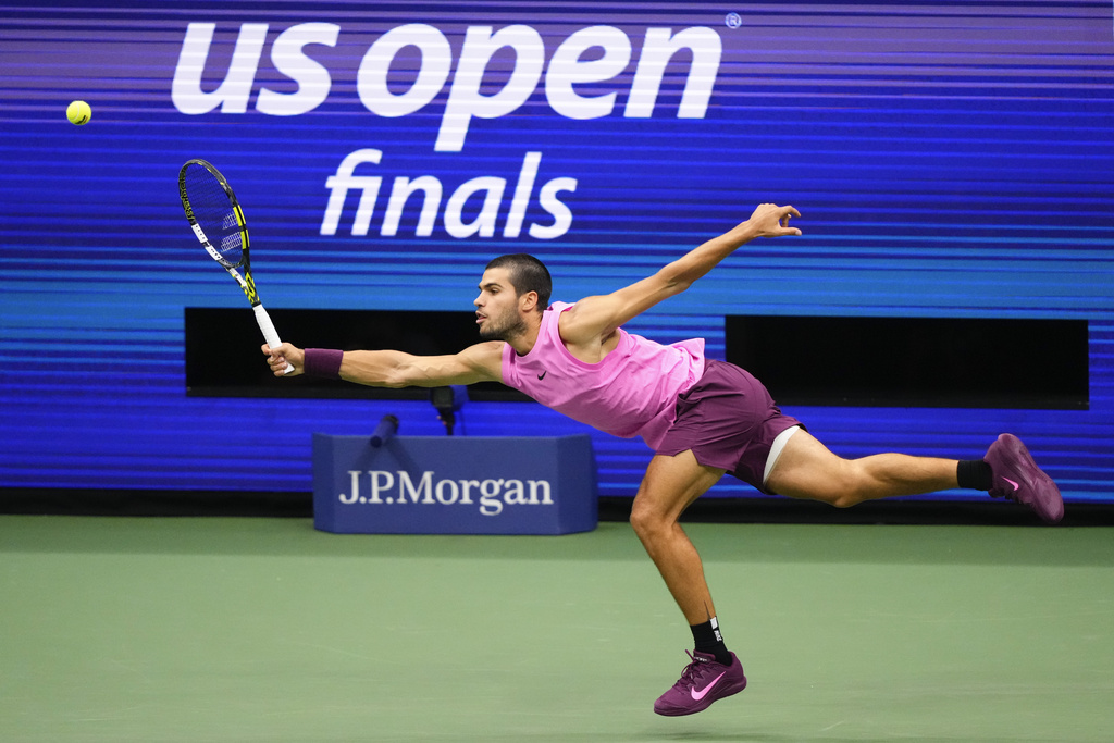 Carlos Alcaraz, of Spain, returns a shot to Jannik Sinner, of Italy, during the men's singles final of the U.S. Open tennis championships, Sunday, Sept. 7, 2025, in New York. (AP Photo/Yuki Iwamura)