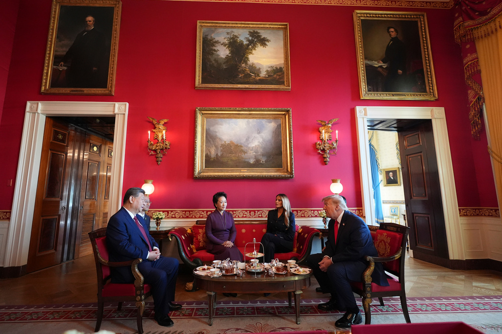 President Donald Trump, from right, and first lady Melania Trump attend a tea with China's President Xi Jinping, from left, and his wife Peng Liyuan in the Red Room of the White House, Friday, Sept. 25, 2026, in Washington. (AP Photo/Jacquelyn Martin)