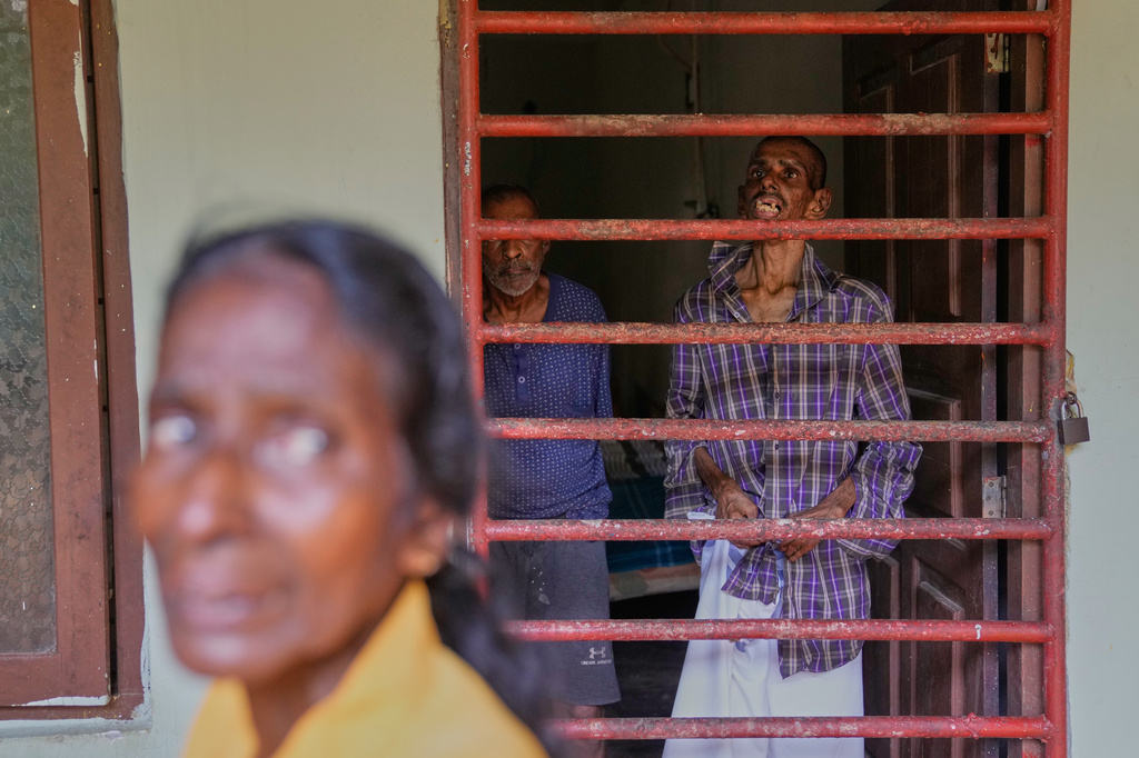 The mother of a resident stands outside a dormitory at a nursing home in Anguruwatota, Sri Lanka, Friday, June 5, 2026. (AP Photo/Eranga Jayawardena)