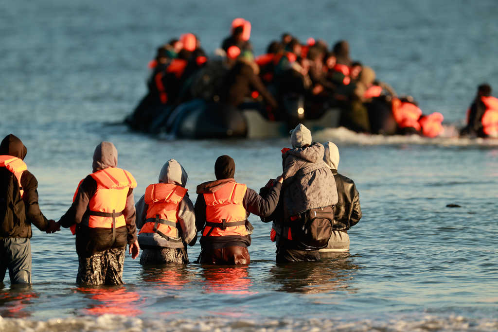 Migrants board a small boat in an attempt to reach Britain, Wednesday, April 8, 2026 in Malo-les-Bains, northern France. (AP Photo/Jean-Francois Badias)
