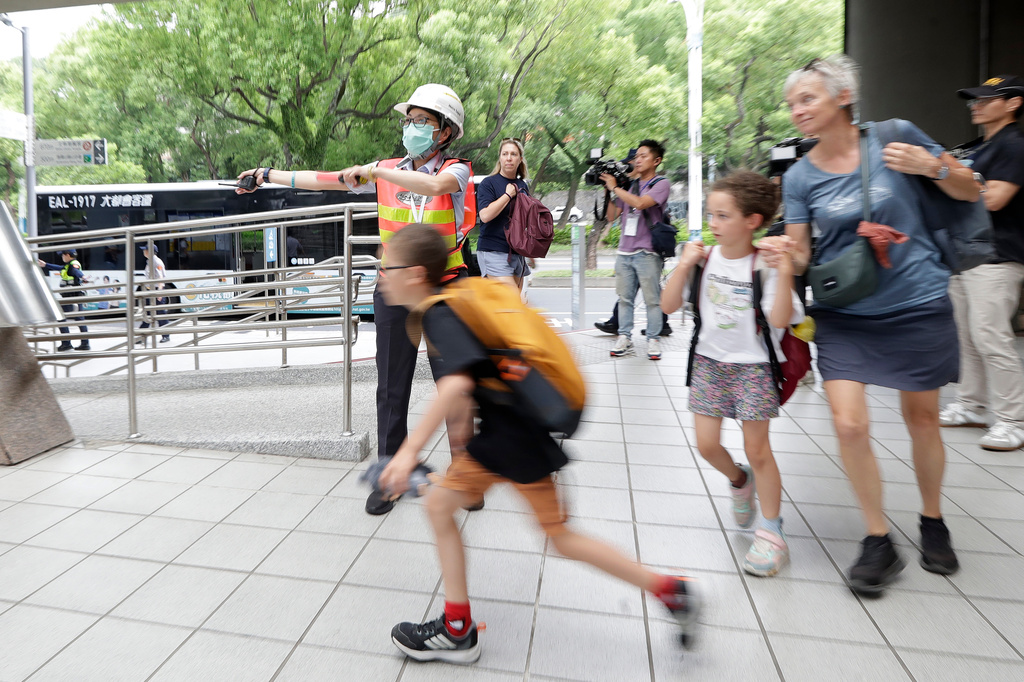 People are guided to a basement shelter at an MRT station during the Urban Resilience (Air-Defense) Exercise, part of the annual Han Kuang military exercises in Taipei, Taiwan, Thursday, Aug. 13, 2026. (AP Photo/Chiang Ying-ying)