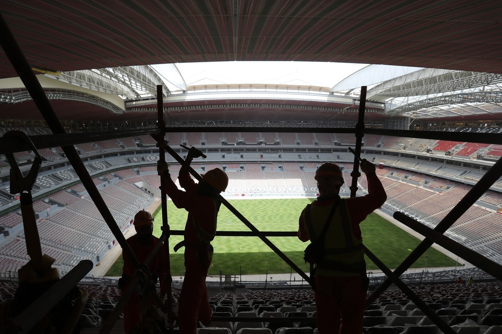 FILE - Laborers remove scaffolding at the Al Bayt stadium in Al Khor, Qatar, about 50 kilometers (30 miles) north of Doha, April 29, 2019. (AP Photo/Kamran Jebreili, File)