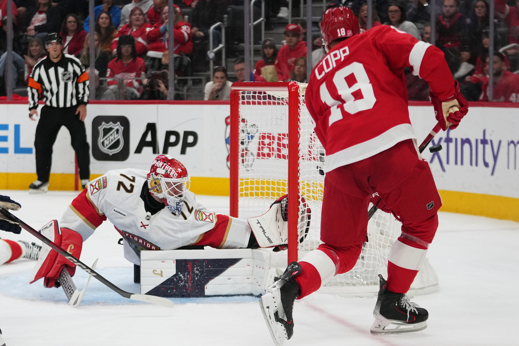 Florida Panthers goaltender Sergei Bobrovsky (72) deflects a Detroit Red Wings center Andrew Copp (18) shot in the second period of an NHL hockey game Wednesday, Oct. 15, 2025, in Detroit. (AP Photo/Paul Sancya)