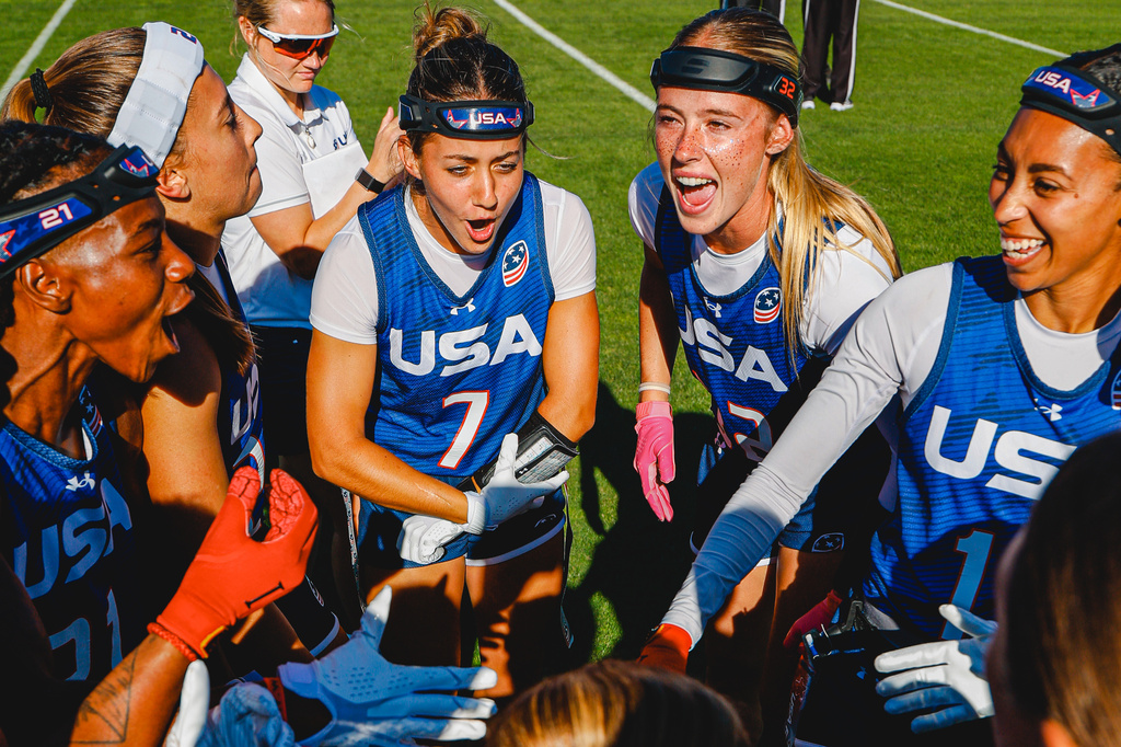 In this image provided by USA Football, USA Football national team players Maci Joncich (7) and Ashlea Klam, second from right, who will be flag football teammates in the fall at Cal Poly in San Luis Obispo, Calif., huddle with their teammates during USA Football's Rivalry Series game against Canada, Sunday, June 19, 2026, at Dignity Health Sports Park in Carson, Calif. (Kelli Tolar/USA Football via AP)