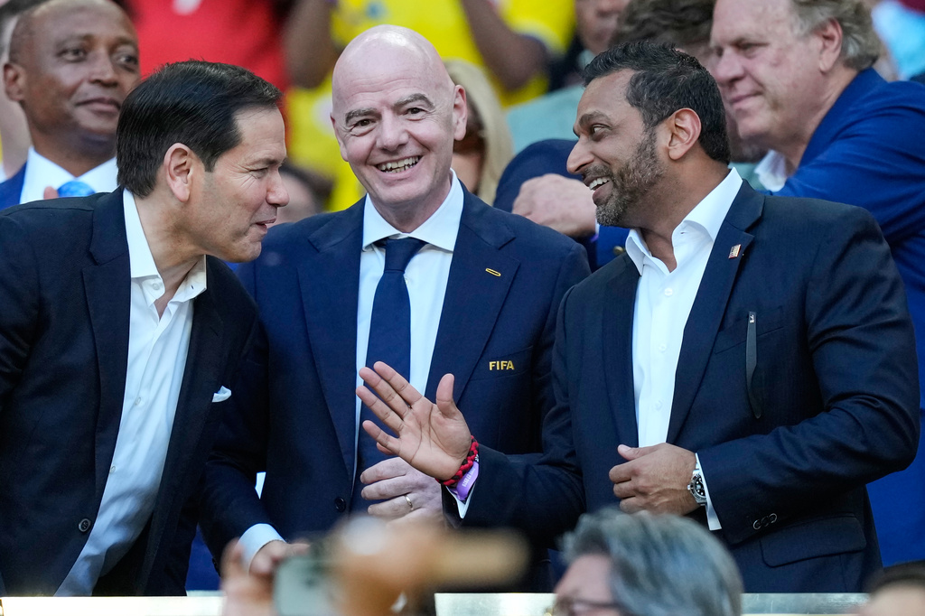 FIFA President Gianni Infantino, center, stands with United States Secretary of State Marco Rubio, left, and Director of the FBI, Kash Patel ahead of the World Cup Group K soccer match between Colombia and Portugal in Miami Gardens, Fla., Saturday, June 27, 2026. (AP Photo/Rebecca Blackwell)