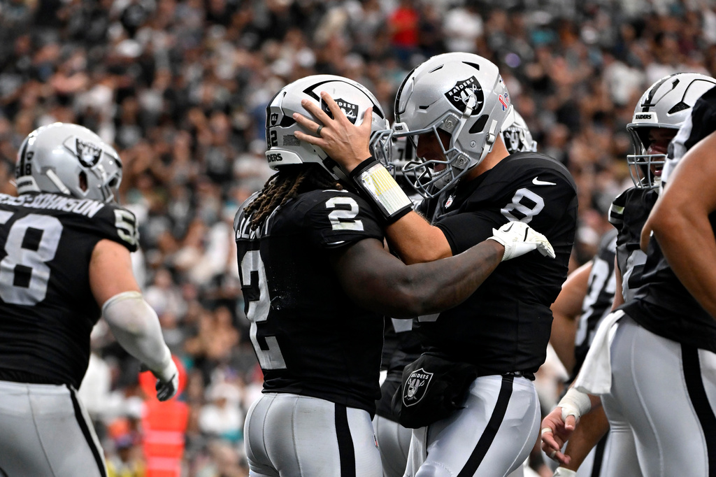 Las Vegas Raiders running back Ashton Jeanty (2) celebrates with teammate quarterback Kirk Cousins (8) after catching a touchdown pass during the first half of an NFL football game against the Miami Dolphins, Sunday, Sept. 13, 2026, in Las Vegas. (AP Photo/David Becker)