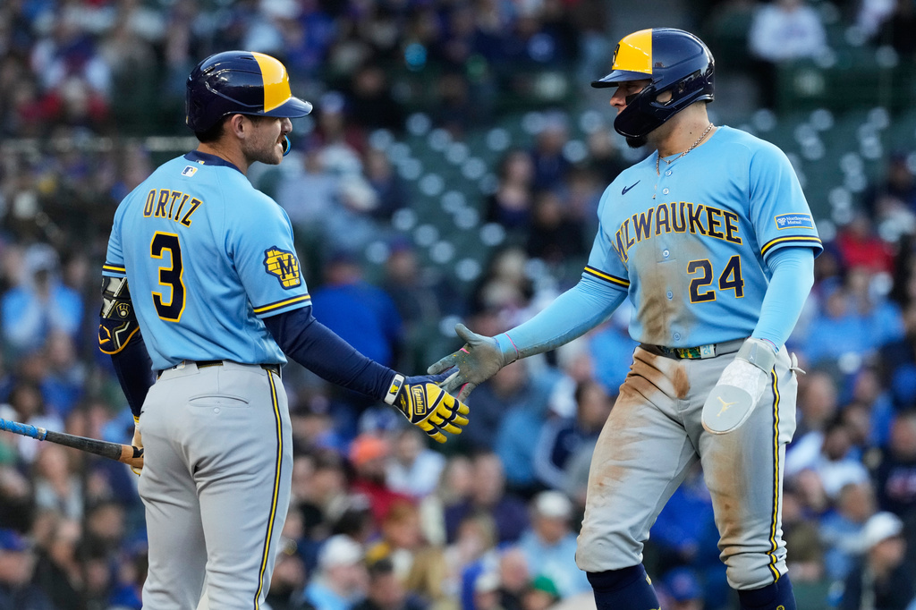 Milwaukee Brewers' William Contreras, right, celebrates with Joey Ortiz after scoring on a one-run single by Jake Bauers during the third inning of a baseball game against the Chicago Cubs in Chicago, Wednesday, May 20, 2026. (AP Photo/Nam Y. Huh)