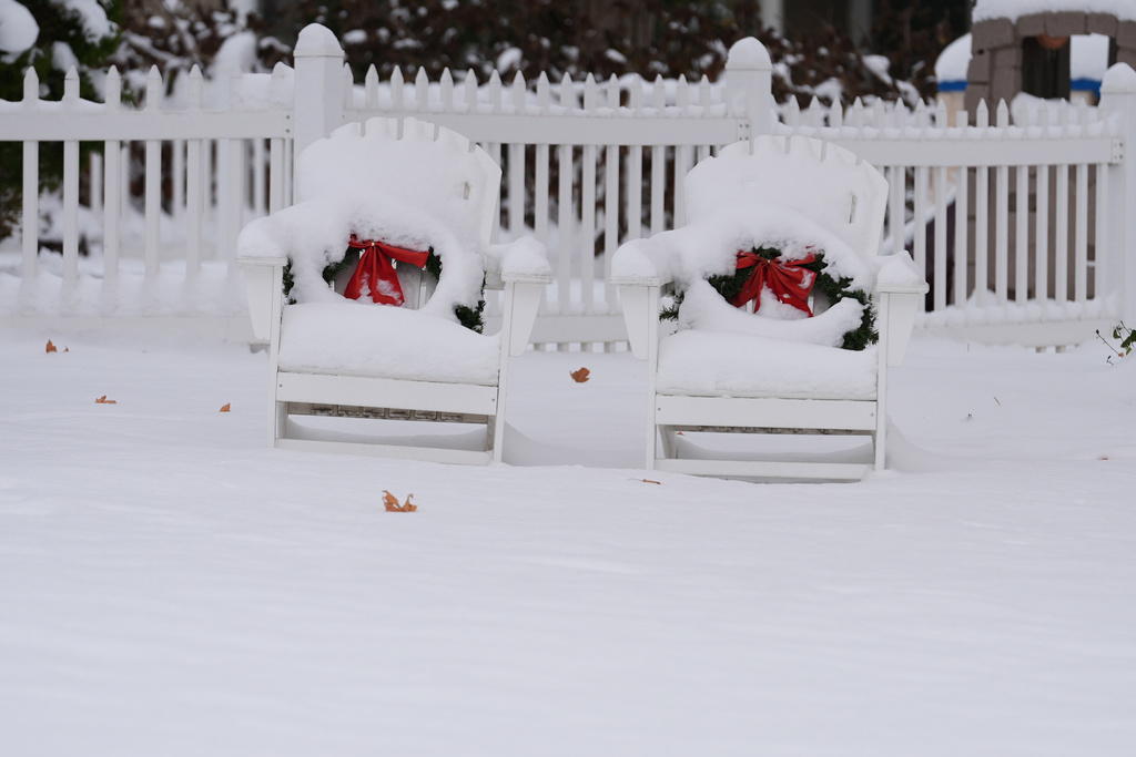 Chairs are covered in snow in Glenview, Ill., Monday, Dec. 1, 2025. (AP Photo/Nam Y. Huh)