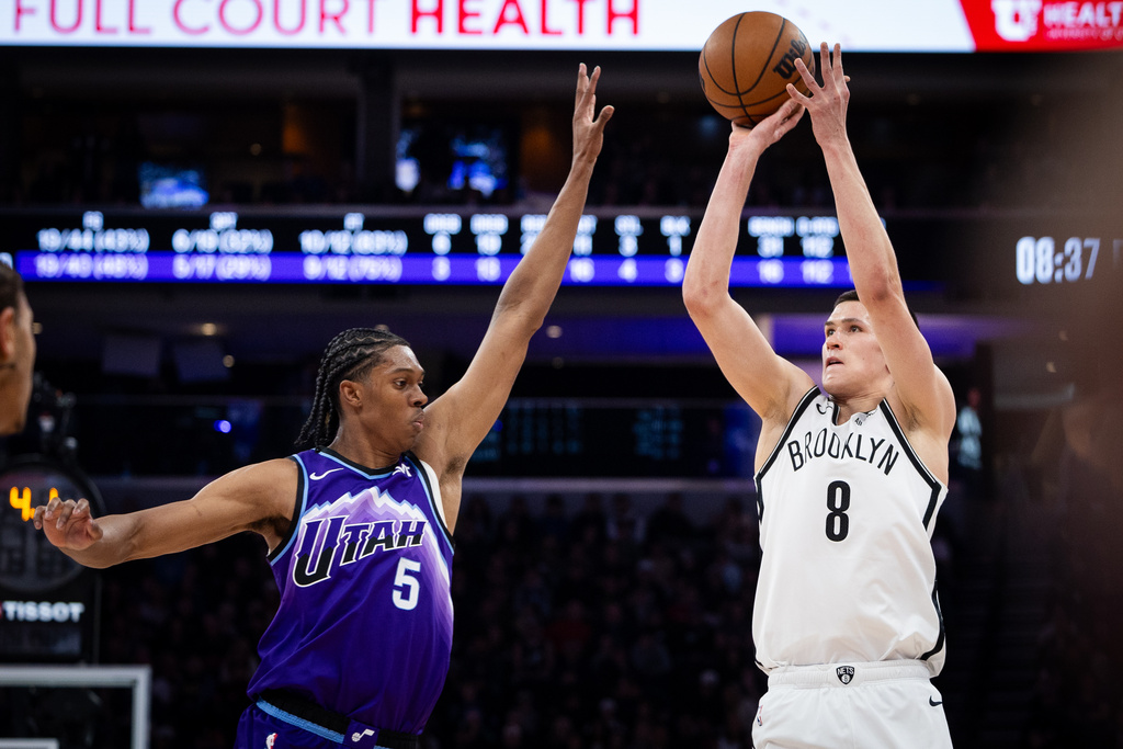 Brooklyn Nets guard Egor Dëmin (8) looks to shoot over Utah Jazz forward Cody Williams (5) during the first half of an NBA basketball game, Friday, Jan. 30, 2026, in Salt Lake City. (AP Photo/Anna Fuder)