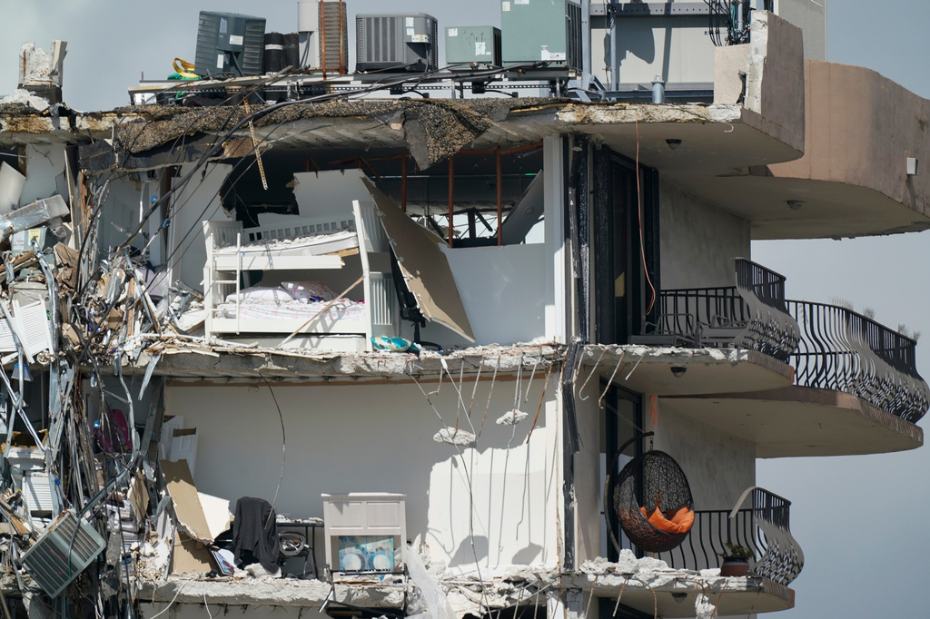 FILE - Furniture sits perched in the remains of apartments sheared in half in the still standing portion of the Champlain Towers South condo building, July 2, 2021, in Surfside, Fla. (AP Photo/Mark Humphrey, File)