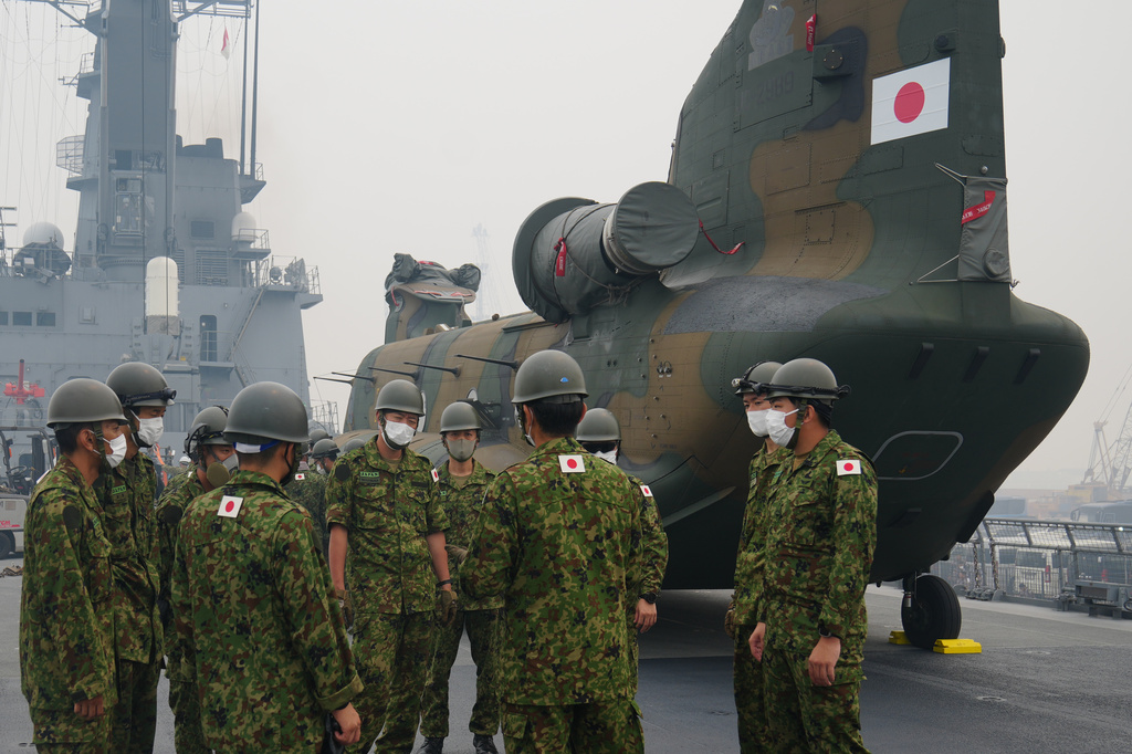 Crew members have a briefing near one of the Chinook helicopters which will be used to help battle forest fires on Kalimantan Island, on the deck of Japanese tank landing ship JS Kunisaki after its arrival at Kijing Port in Mempawah, West Kalimantan, Indonesia, Thursday, Sept. 10, 2026. (AP Photo/Tatan Syuflana)