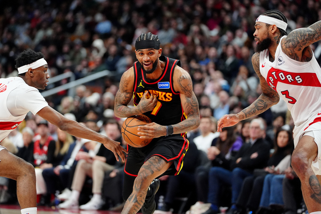 Atlanta Hawks guard Nickeil Alexander-Walker, center, has the ball stripped by Toronto Raptors guard Ja'kobe Walter, left, as Raptors' Brandon Ingram (3) looks on during second-half NBA basketball game action in Toronto, Monday, Jan. 5, 2026. (Frank Gunn/The Canadian Press via AP)