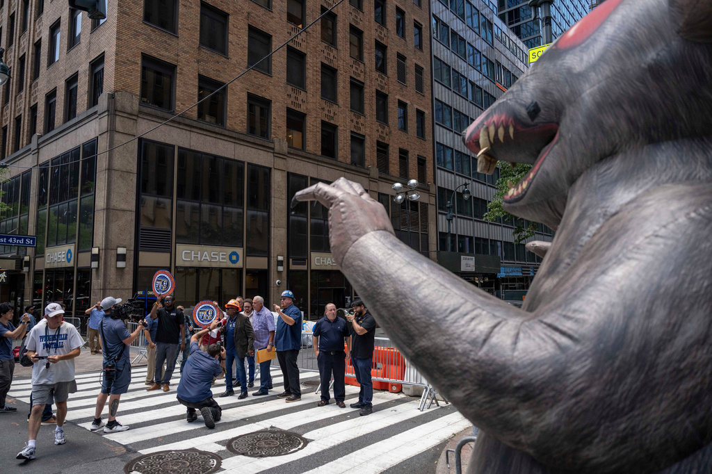 An inflatable rat is placed as members of construction laborers union Local 79, hold a rally near 235 East 42nd Street, Wednesday, July 8, 2026, in New York. (AP Photo/Yuki Iwamura)