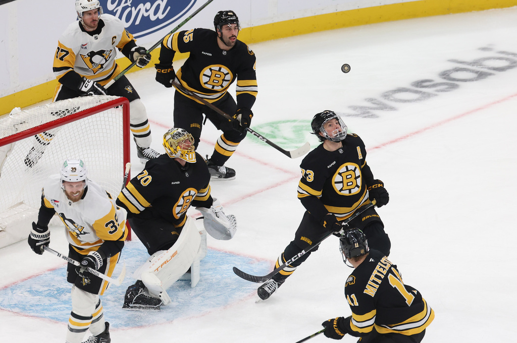 Boston Bruins goaltender Joonas Korpisalo (70) and defenseman Charlie McAvoy (73) watch the puck during the first period of an NHL hockey game against the Pittsburgh Penguins, Sunday, Jan. 11, 2026, in Boston. (AP Photo/Mark Stockwell)