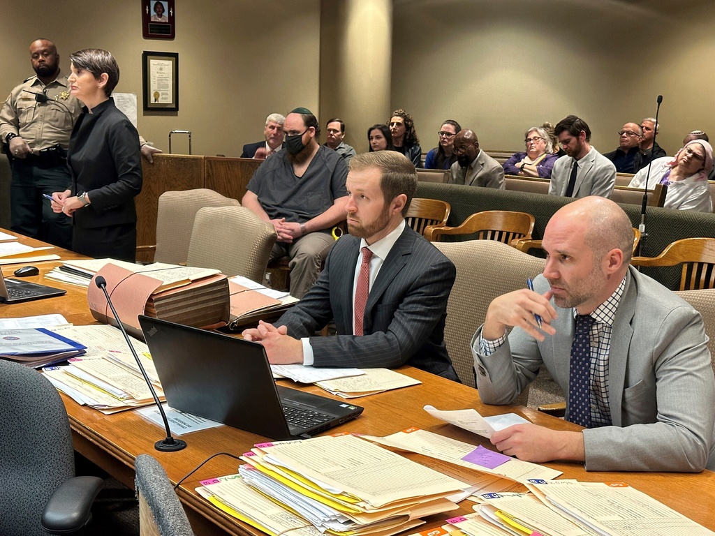 FILE - Joel Bowman, center-left, seated with mask, listens to witness testimony as his lawyer, Lauren Massey Fuchs, left, prosecutor Forrest Edwards, center-right, and prosecutor John Scott, right listens during a bond hearing on Monday, Jan. 8, 2024, in Memphis, Tenn. (AP Photo/Adrian Sainz, File)