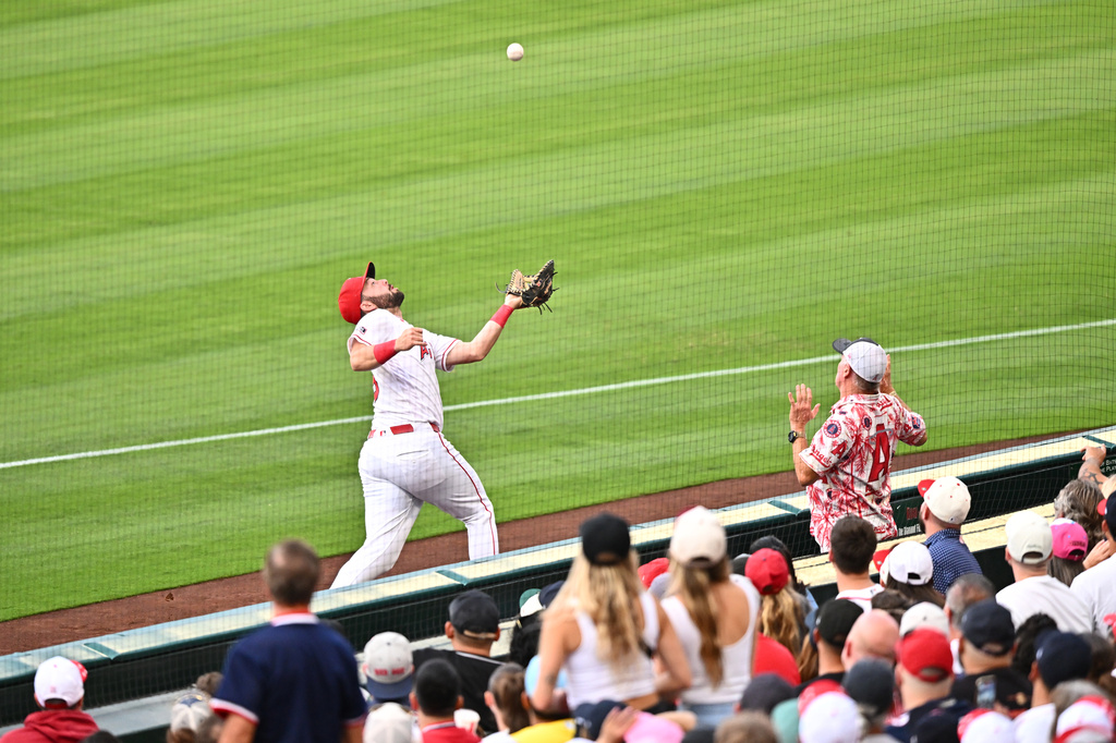 Los Angeles Angels first baseman Nolan Schanuel, left, makes a catch during the third inning of a baseball game against the Boston Red Sox, Friday, July 3, 2026, in Anaheim, Calif. (AP Photo/William Liang)