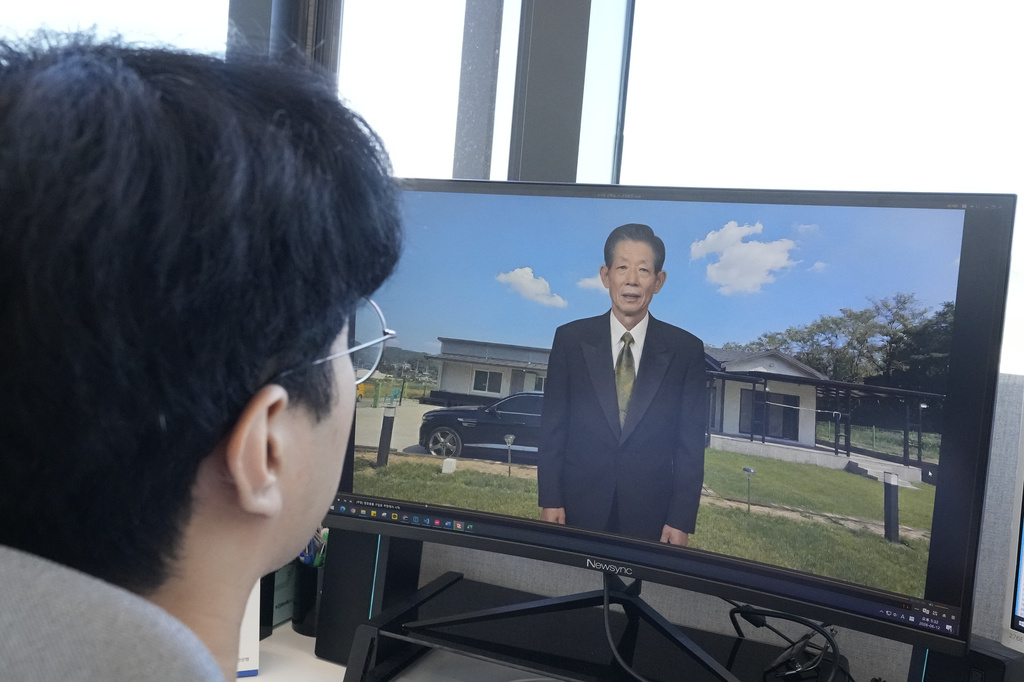 Lee Geon Hui looks at a computer screen as a video clip shows a digital likeness of his late grandfather speaking at Seoul-based tech firm Vaice, South Korea, Friday, June 12, 2026. (AP Photo/Ahn Young-joon)