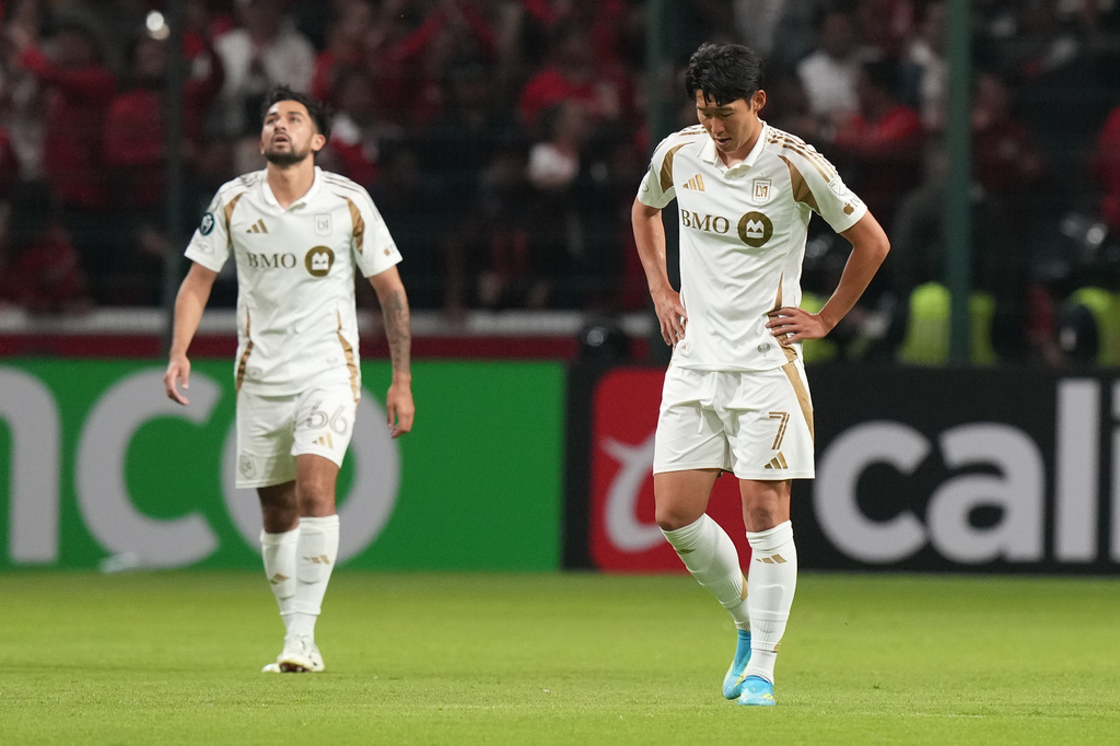 Son Heung-Min, right, and Mathieu Choiniere of the United States' Los Angeles FC react after Everardo Lopez of Mexico's Toluca scored during a CONCACAF Champions Cup second leg semifinal soccer match in Toluca, Mexico, Wednesday, May 6, 2026. (AP Photo/Fernando Llano)