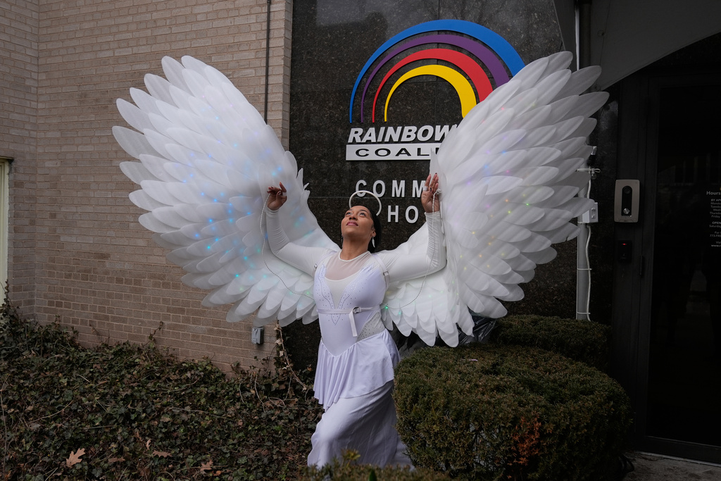 Phoenix Ellington dressed as an angel spreads her wings at a public visitation for the Rev. Jesse Jackson at Rainbow PUSH Coalition headquarters, Thursday, Feb. 26, 2026, in Chicago. (AP Photo/Erin Hooley)