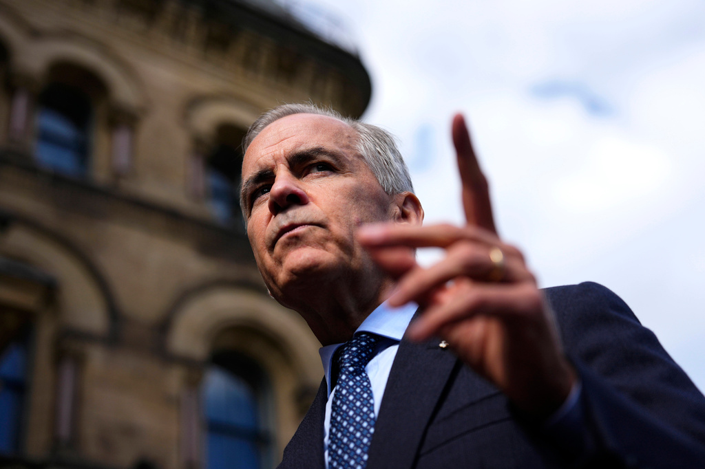 Canadian Prime Minister Mark Carney speaks with members of the media as he arrives at the Office of the Prime Minister and Privy Council in Ottawa, on Tuesday, Sept. 1, 2026. (Justin Tang/The Canadian Press via AP)