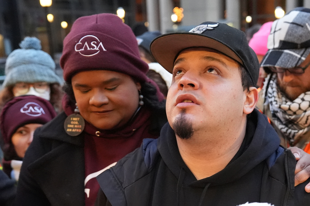 Kilmar Abrego Garcia waits with Lydia Walther-Rodriguez of Casa in Maryland, left, to enter the building for a mandatory check at the Immigration and Customs Enforcement office in Baltimore, Friday, Dec. 12, 2025, after he was released from detention on Thursday under a judge's order. (AP Photo/Stephanie Scarbrough)