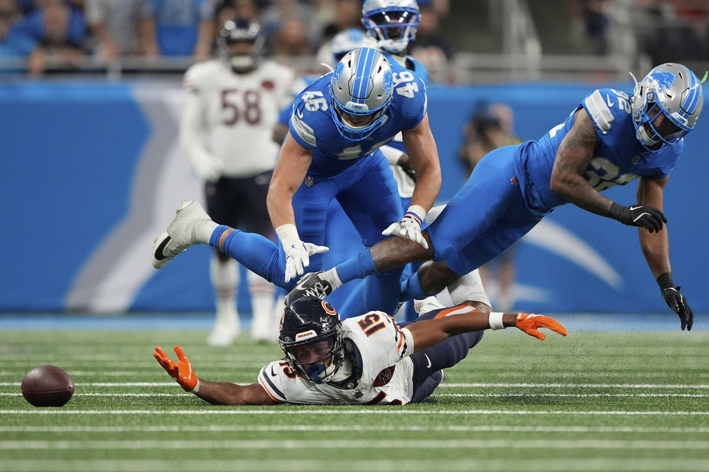 Chicago Bears wide receiver Rome Odunze (15) can't make a catch as his is defended by Detroit Lions linebacker Jack Campbell (46) and safety Brian Branch (32) during the second half of an NFL football game in Detroit, Sunday, Sept. 14, 2025. (AP Photo/Ryan Sun)