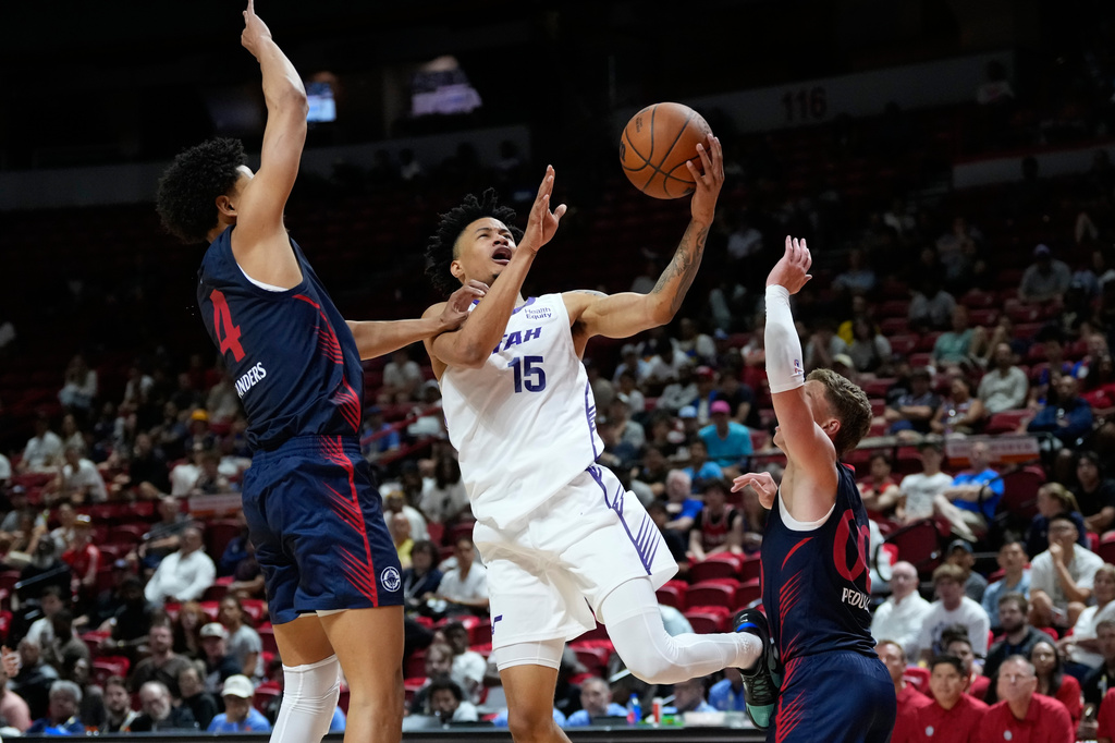 Utah Jazz's Trey Alexander shoots against LA Clippers' Kobe Sanders, left, and LA Clippers' Sean Pedulla during the second half of an NBA Summer League basketball game Sunday, July 12, 2026, in Las Vegas. (AP Photo/John Locher)