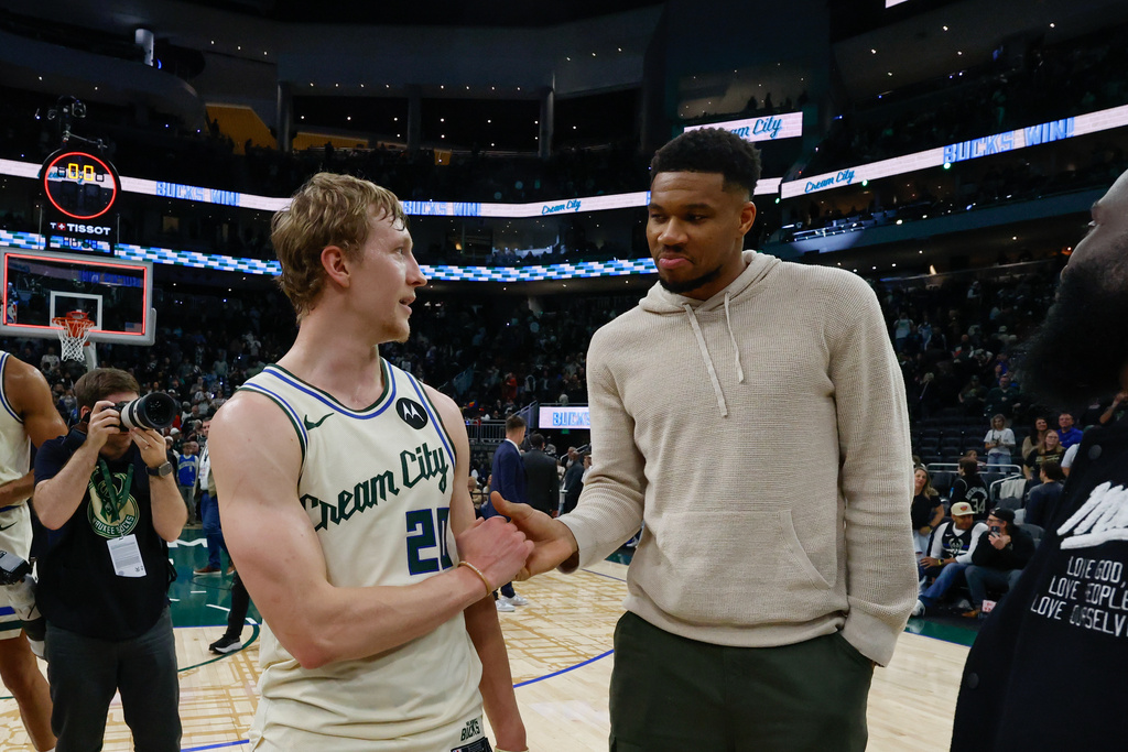 Milwaukee Bucks forward Giannis Antetokounmpo, right, congratulates Milwaukee Bucks guard AJ Green (20) after an NBA basketball game against the Brooklyn Nets, Friday, April 10, 2026, in Milwaukee. (AP Photo/Jeffrey Phelps)