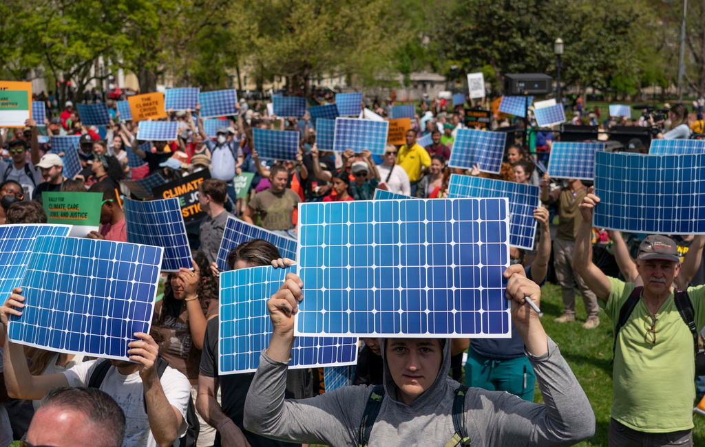 FILE - Activists display prints replicating solar panels during a rally to mark Earth Day at Lafayette Square, Washington, April 23, 2022. (AP Photo/Gemunu Amarasinghe, File)