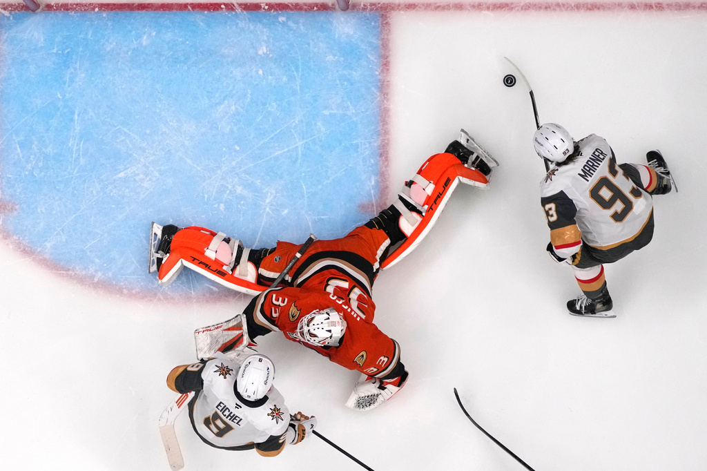 Vegas Golden Knights right wing Mitch Marner, right, scores on Anaheim Ducks goaltender Ville Husso, center, as center Jack Eichel watches during the second period in Game 3 of a second-round NHL hockey Stanley Cup playoff series Friday, May 8, 2026, in Anaheim, Calif. (AP Photo/Mark J. Terrill)