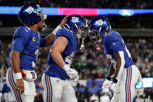 New York Giants' Russell Wilson, from left, Cam Skattebo and Tyrone Tracy Jr. celebrate after a touchdown during the second half of an NFL football game against the Philadelphia Eagles Thursday, Oct. 9, 2025, in East Rutherford, N.J. (AP Photo/Adam Hunger) New York Giants' Russell Wilson, from left, Cam Skattebo and Tyrone Tracy Jr. celebrate after a touchdown during the second half of an NFL football game against the Philadelphia Eagles Thursday, Oct. 9, 2025, in East Rutherford, N.J. (AP Photo/Adam Hunger)
