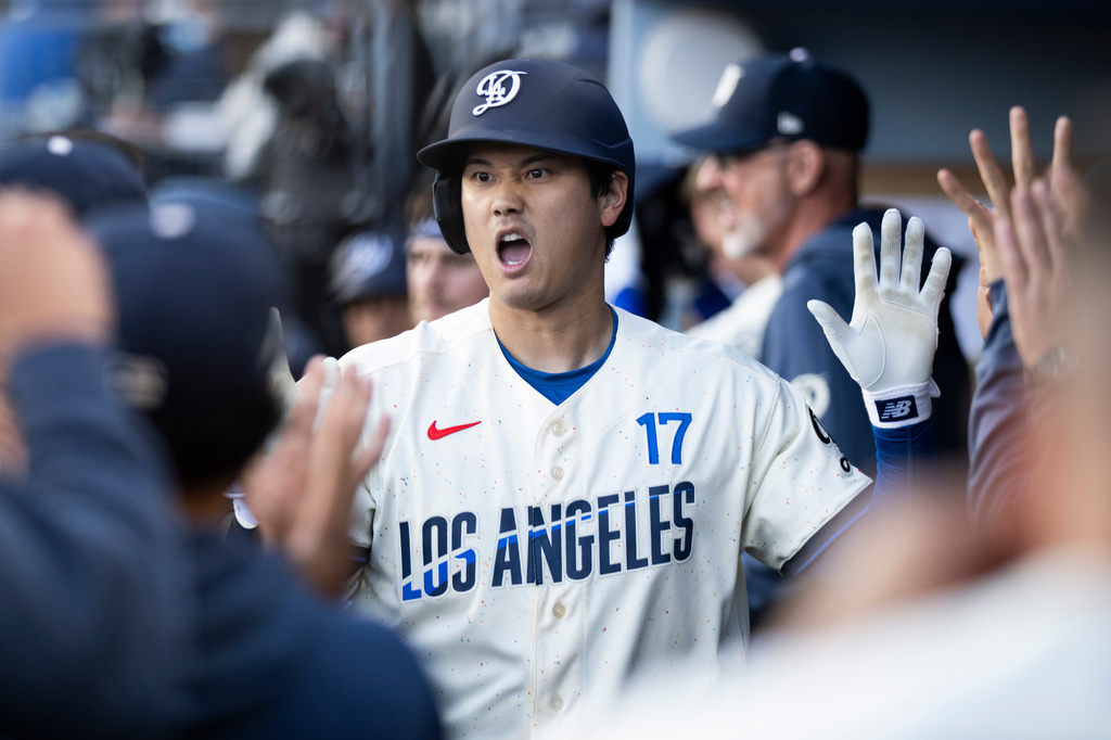 Los Angeles Dodgers' Shohei Ohtani celebrates his solo home run with the bench during the first inning of a baseball game against the Texas Rangers in Los Angeles, Saturday, April 11, 2026. (AP Photo/Kyusung Gong)