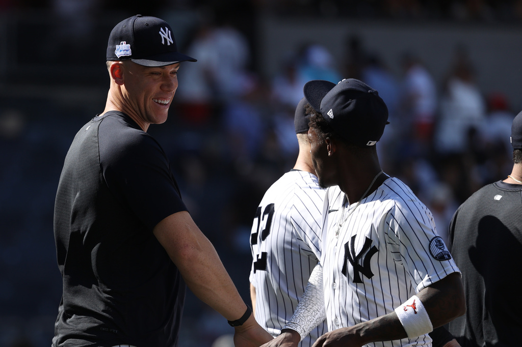 New York Yankees' Aaron Judge, left, celebrates with Jazz Chisholm Jr. after defeating the Boston Red Sox at a baseball game, Sunday, June 7, 2026, in New York. (AP Photo/Pamela Smith)