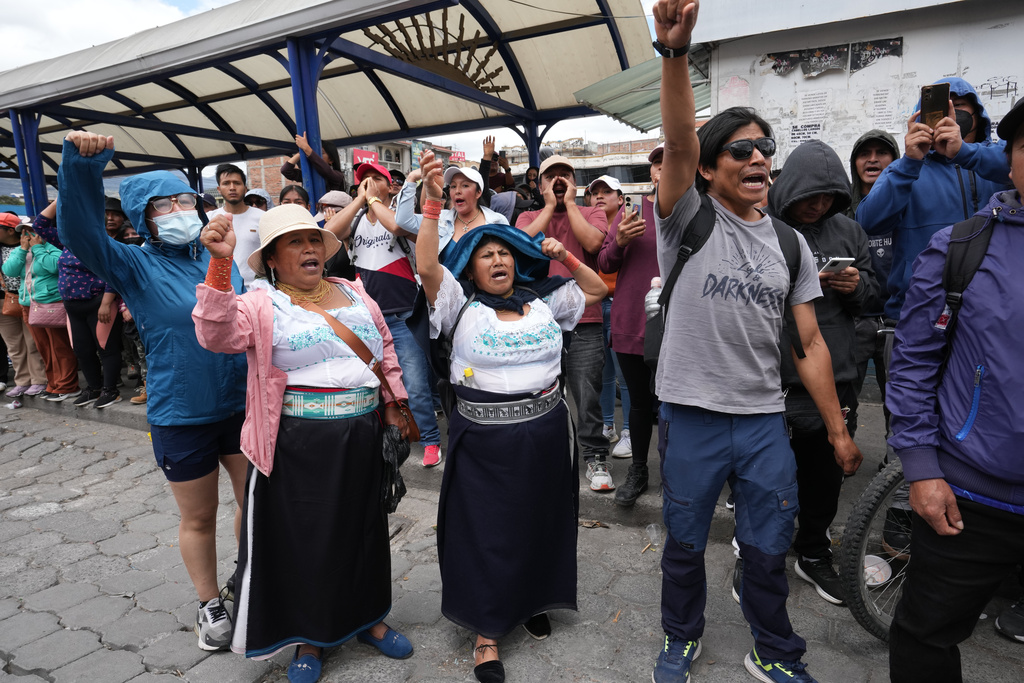 Protesters jeer at Ecuador's President Daniel Noboa as he exits an event in Otavalo, Ecuador, Wednesday, Sept. 24, 2025. (AP Photo/Dolores Ochoa)