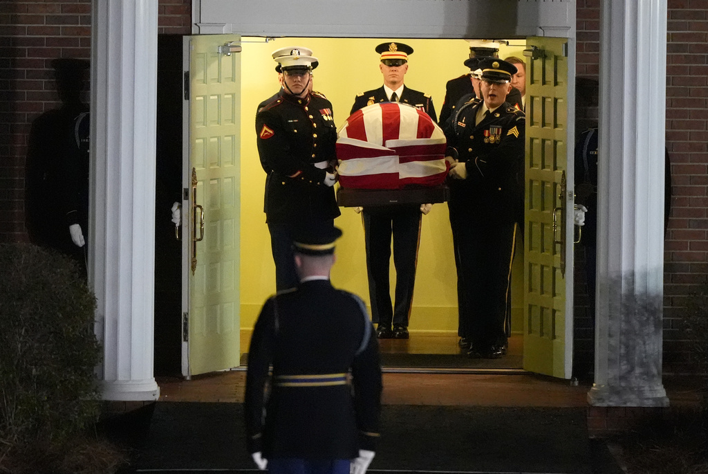 The flag-draped casket of former President Jimmy Carter is carried to a hearse after a funeral service at Maranatha Baptist Church, Thursday, Jan. 9, 2025, in Plains, Ga. (AP Photo/Mike Stewart)