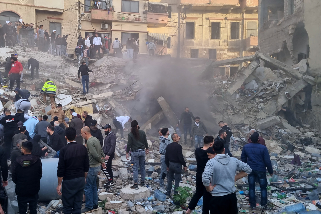 Rescue workers and residents search for survivors in the rubble of a building that collapsed in the northern city of Tripoli, Lebanon, Sunday, Feb. 8, 2026. (AP Photo)