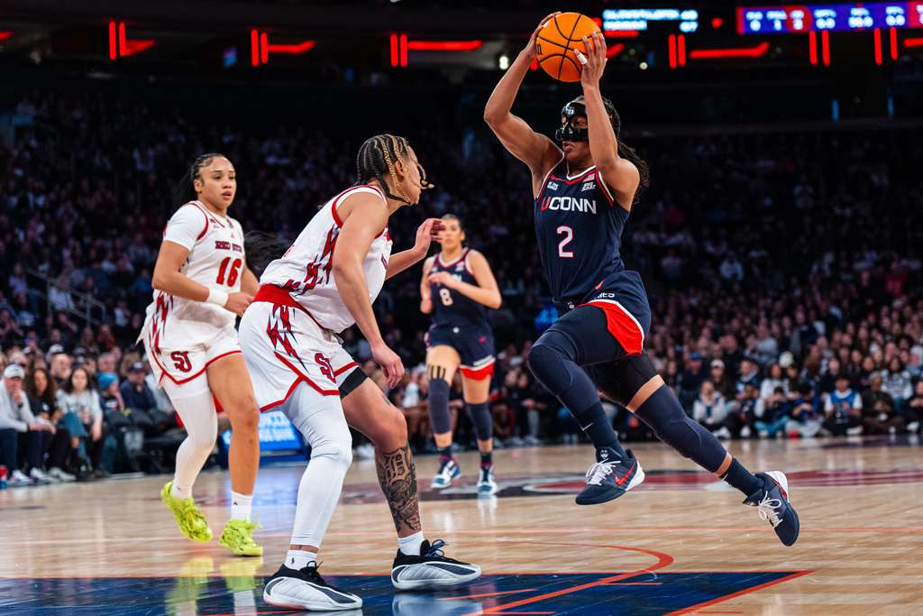 UConn guard Kamorea "KK" Arnold (2) heads toward the basket during the first half of an NCAA college basketball game against St. John's, Sunday, March 1, 2026, in New York. (AP Photo/Angelina Katsanis)