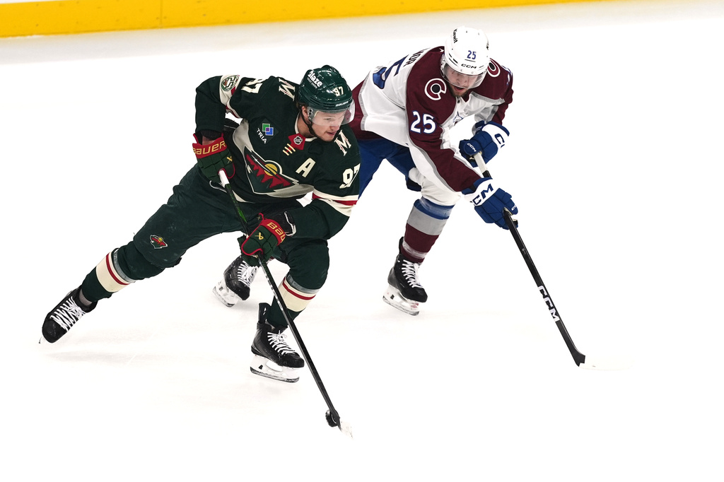 Minnesota Wild left wing Kirill Kaprizov (97) skates with the puck as Colorado Avalanche right wing Logan O'Connor (25) defends during the first period of Game 3 of an NHL Stanley Cup hockey second-round playoff series Saturday, May 9, 2026, in St. Paul, Minn. (AP Photo/Abbie Parr)