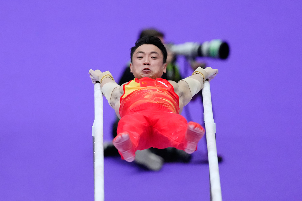 China's Zou Jingyuan competes on the parallel bars during the men's team artistic gymnastics final at the Asian Games in Nagoya, Japan, Wednesday, Sept. 23, 2026. (AP Photo/Eugene Hoshiko)